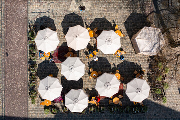 Aerial view on umbrellas in outdoor cafe in Lviv, Ukraine from drone © Ruslan