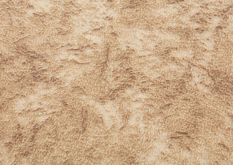Background of light beige paper wallpaper with textured dark chaotic spots.
