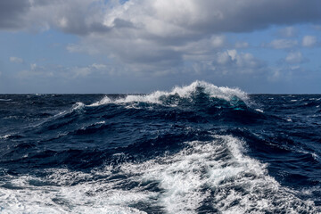 Beautiful seascape - waves and sky with clouds with beautiful lighting. Stormy sea, Bad weather. Gale. Rough sea. Beaufort scale 6.