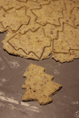 Close-up of raw dough for salty cookies with walnuts on a gray table