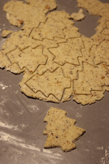 Close-up of raw dough for salty cookies with walnuts on a gray table