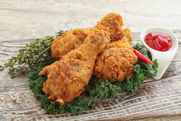 Fried chicken drumsticks with tomato sauce