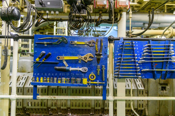 Instrument board on vessel. Spanners. Engine room interior.