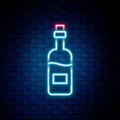 Glowing neon line Bottle of wine icon isolated on brick wall background. Colorful outline concept. Vector