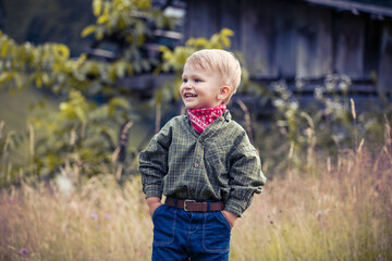 Cute Little Boy in Western Costume with Jeans and Bandana - 702191327