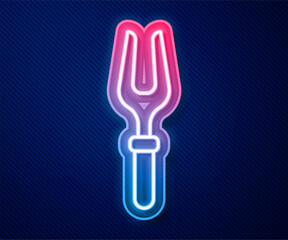 Fototapeta premium Glowing neon line Barbecue fork icon isolated on blue background. BBQ fork sign. Barbecue and grill tool. Vector