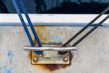 Cleat Hitch with blue rope. Marine hardware. Yachting concept.