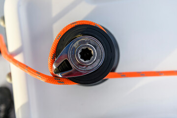 Yacht winch with orange rope on sailing boat. Top view. Yachting concept. - obrazy, fototapety, plakaty