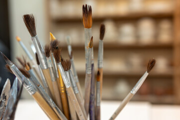 A set of tools, brushes for sculpting from clay in the workshop, drawing, at the workplace. Close...