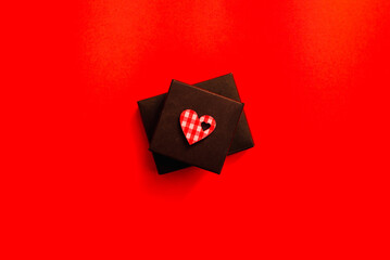 valentine's day black box gift, heart, red surface, top view,copy space.