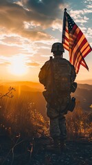 A soldier stands proudly holding an American flag against a setting sun. Silhouette of a soldier...