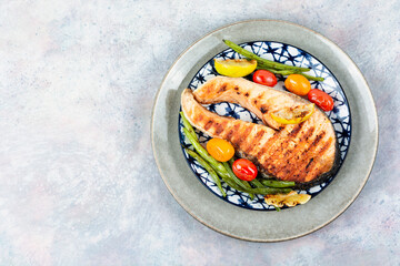 Grilled trout steak on a plate.