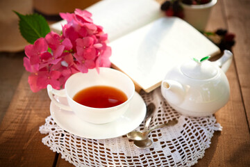 Composition of tea and book on table