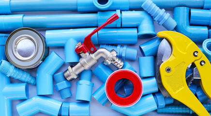 Plumber equipment with blue pvc pipe connections for plumbing work.