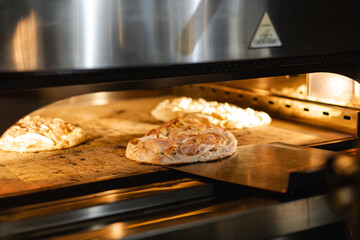 Baking Roman pizza with toppings