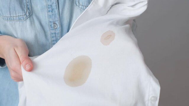 Dirty stains of coffee on a white shirt. daily life stain concept. 4k footage