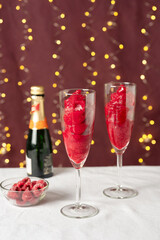 Rasperry sorbet with champagne in long glasses for Valentines Day celebration