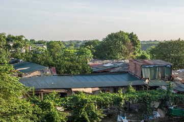 View od tin shack roof tops, located just outside Hanoi, northen Vietnam.  The shacks are located amoungst dense foliage 
