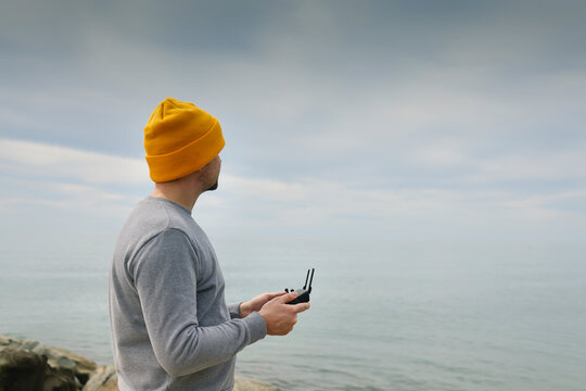 Male hands holding dron remote controller doing some setings ready to run it into the sky