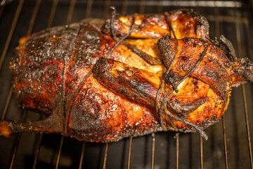 Whole roasted peking duck on baking grid.