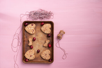 Valentine's day treats for your canine friends.  Baked cranberry puppy biscuits on stoneware baking...