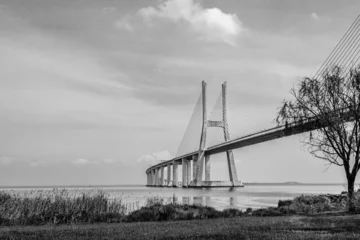 Cercles muraux Pont Vasco da Gama Vasco da Gama bridge in Lisbon, Portugal  cable stayed bridge flanked by viaducts and rangeviews that spans the Tagus river in Parque das Nacoes, the second longest bridge in Europe in black and white