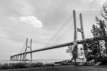 Vasco da Gama bridge in Lisbon, Portugal  cable stayed bridge flanked by viaducts and rangeviews that spans the Tagus river in Parque das Nacoes, the second longest bridge in Europe in black and white