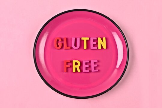 Gluten Free  lettering on a pink plate. Nutritional concept. 