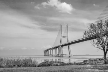 Papier Peint photo Pont Vasco da Gama Vasco da Gama bridge in Lisbon, Portugal  cable stayed bridge flanked by viaducts and rangeviews that spans the Tagus river in Parque das Nacoes, the second longest bridge in Europe in black and white