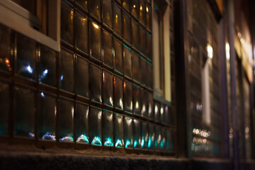 Night traffic lights reflected on a window
