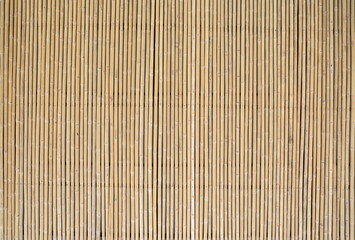 Fences are made from small dried bamboo trees. Walls are ideal for garden decoration or decorate the place. Old brown tone bamboo plank. Pattern of bamboo fencing texture 
