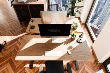 Naklejka premium top down perspective of modern minimalistic pc workspace in luxurious loft office and panoramic view; remote work home office concept; bright daylight; 3D rendering