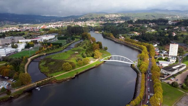 Cinematic aerial perspective of Pontevedra city. Drone going forward revealing the beautiful landscape. Famous travel destination in Galicia. River Lerez and Ponte da Illa do Covo