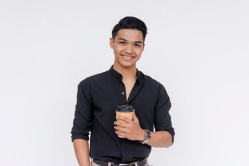 A young fashionable and dapper filipino guy holding a hot cup of coffee. Half body photo, isolated on a white background. - obrazy, fototapety, plakaty
