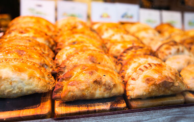 Freshly baked empanadas with different fillings for sale
