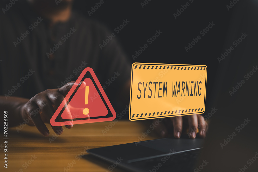 Poster User is using computer with triangle caution warning sign for notification error and maintenance concept. Hacker attacks and hacking data, cyber crime, Ransomware, Phishing, Spyware, cybersecurity.