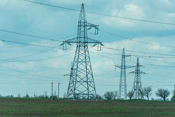 High voltage towers with sky background. Power line support with wires for electricity transmission. High voltage grid tower with wire cable at distribution station. Energy industry, energy saving