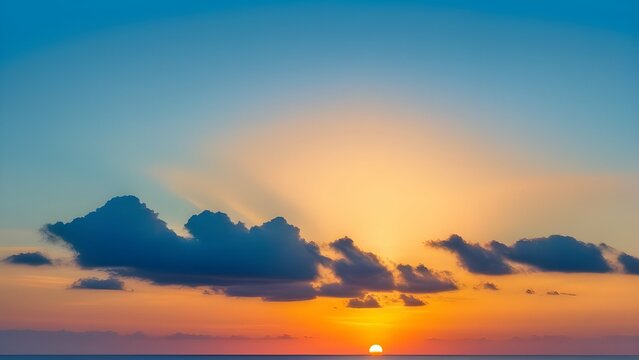 A minimalist and simple frame of a beautiful sunset, with a single cloud, painted in bold and stunning hues, against a canvas of a clear blue sky.
