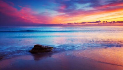 Fototapeta na wymiar Colorful sunrise sky in purple hues over the ocean.