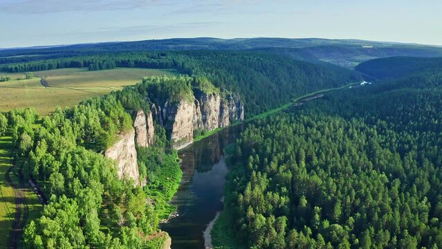 Aiskie pritesi rocks. Aerial view of river Ai and famous rocky cliffs in green forest at Ural mountains