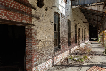 Long abandoned brick warehouse with tall windows - 702275900