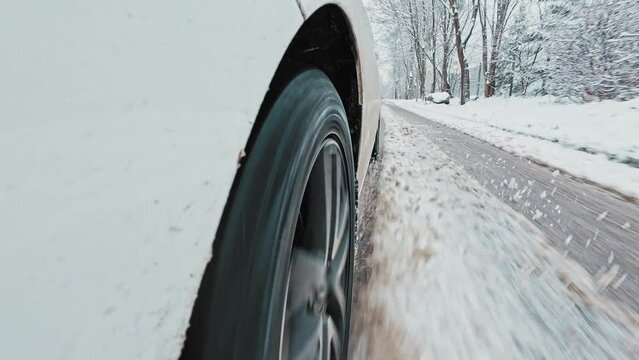 Car Front Winter Tyre Close Up Driving Through Slushy Mud Snow Covered Icy Road