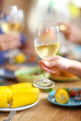 Hands of a group of people cheering with white wine