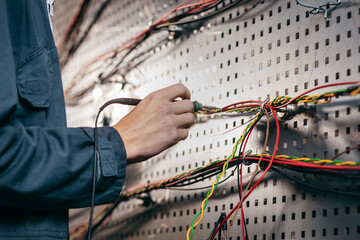Close up hands of engineer soldering wires