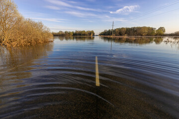 Road flooded with water, natural disaster, spring flood.