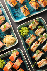 Assorted sushi nigiri and maki big set on slate. A variety of Japanese sushi with tuna, crab, salmon, eel and rolls. Top view