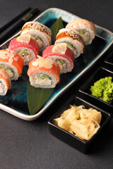 Assorted sushi nigiri and maki big set on slate. A variety of Japanese sushi with tuna, crab, salmon, eel and rolls. Top view