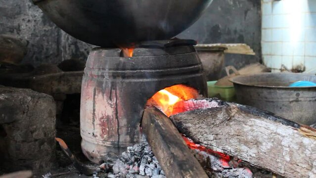 Anglo is a traditional stove or furnace made from clay on old Javanese kitchen set. Firewood as fuel. Fire is burning