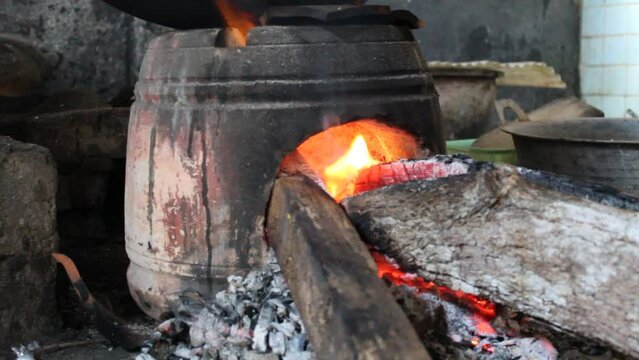 Anglo is a traditional stove or furnace made from clay on old Javanese kitchen set. Firewood as fuel. Fire is burning
