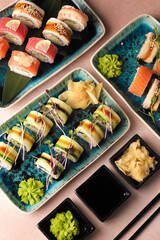 Assorted sushi nigiri and maki big set on slate. A variety of Japanese sushi with tuna, crab, salmon, eel and rolls. Top view